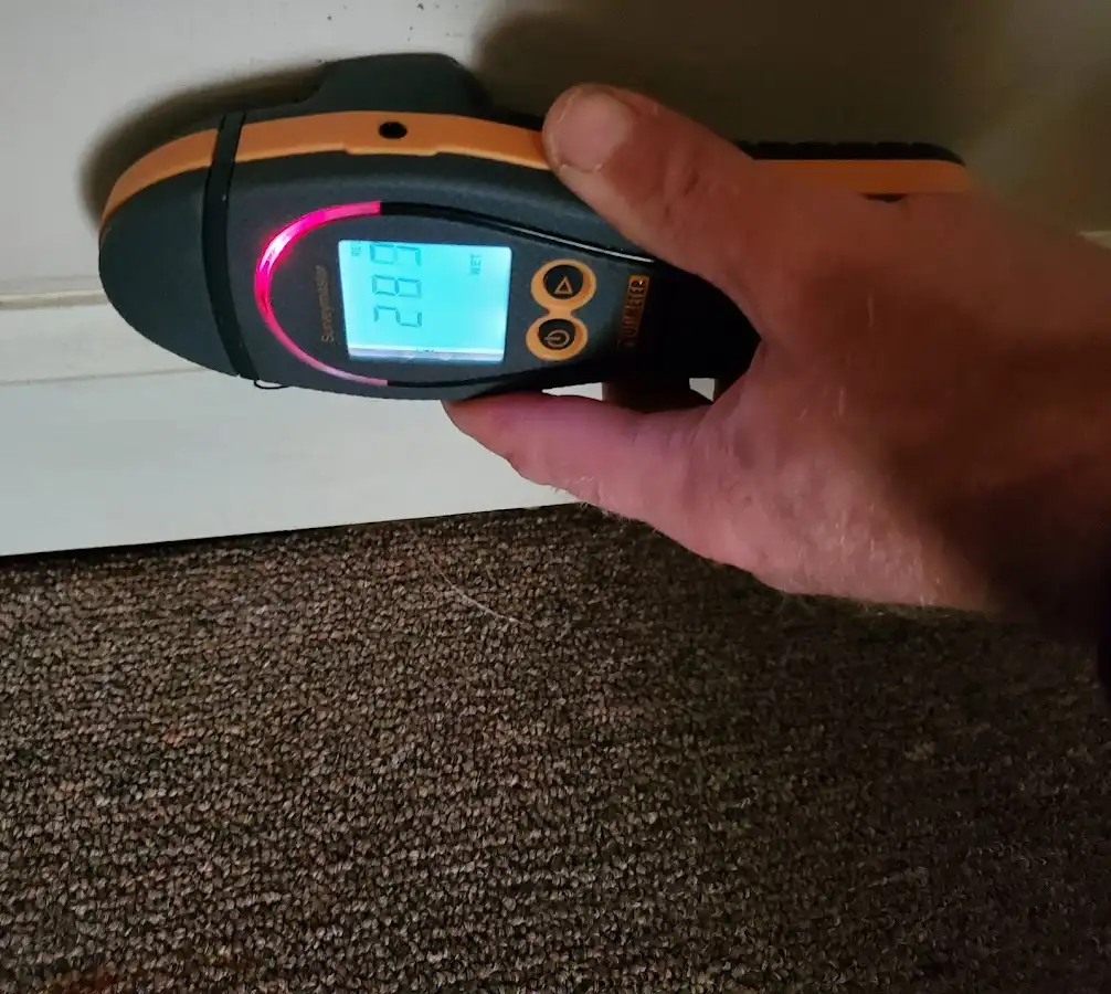 Moisture detection at baseboard during Storm Damage Restoration in West Odessa